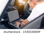 Auto mechanic (ECU tuning) with a notebook computer