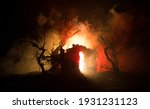 Small photo of Old stone house burning uncontrollable in the night. A fire in a country house. Creative artwork decoration. Selective focus