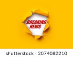 Bright yellow torn paper inside in a hole Breaking news on a white background 