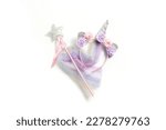 Small photo of Fairy costume, unicorn on a white background. Top view, flay lay.