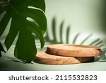 Small photo of Wooden podium with leaves and shadows. Realistic wood platform for product presentation. Minimal nature scene with pedestal mockup. cosmetic display or award ceremony