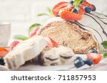 Fresh sweet braided bread in white chocolate with fresh berries