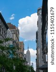 Small photo of Clouds move over the Empire State Building at Fifth Avenue Midtown Manhattan New York USA on June 26 2017.