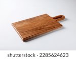 Dark brown rectangle wooden background with a handle positioned on the top right shot isolated on white background with soft shadows high angle view