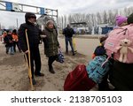 Small photo of Ukranian refugees who fleeing the conflict in Ukraine cross the Moldova-Ukraine border checkpoint near the town of Palanca, on March 14, 2022, after Russia' military invasion of Ukraine.