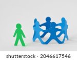 Group of people holding hands in circle and person alone - Concept of social exclusion and isolation
