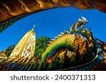 Small photo of Pagoda at Phrathat Nong Bua Temple in Ubonratchatani.Thailand. showing the great nagas in front of the pagoda
