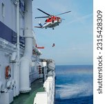 Small photo of Air-sea rescue operations. Red rescue helicopter and Oil Tanker Ship . rescue team. The Coast security. The accident on the water. Ship have Emergency Accident. Training air sea recue operations.