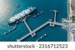 Small photo of LNG (Liquified Natural Gas) tanker anchored in Gas terminal gas tanks for storage. Oil Crude Gas Tanker Ship. LPG at Tanker Bay Petroleum Chemical or Methane freighter export import transportation