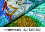 Small photo of silk fabric in a palette drawn by the artist, bright colors, brown-yellow blue color, unbridled fantasy, texture, background, pattern, wallpaper