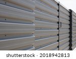 Close up of corrugated metal fence,  horizontal modern metal fence