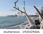 View of Oshawa Harbour shoreline with winter ice formations in Oshawa, Ontario, Canada