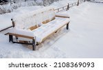 Snow Covered Bench Sunk In The...