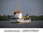 Small photo of Samut Prakan, Thailand-May 20 2023: Sandon 7 Dredger ship of Port Authority of Thailand weigh anchor in the Chaopraya river.