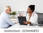 Small photo of Depressed male senior adult in ambulance with afro american doctor. Doctor support and comforting her patient with sympathy