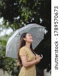 Asian Woman Smiling In The Rain ...