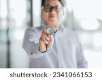 Small photo of Asian doctor holds stethoscope to insinuate that it's time for a check up healthcare, Medical staff, Professional healthcare service concept.
