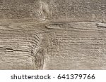 Small photo of The relief texture of the surface of the old wooden board with poor processing, the expressive direction of the wood fibers and the cutoff point of the knot
