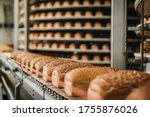 Small photo of Loafs of bread in a bakery on an automated conveyor belt