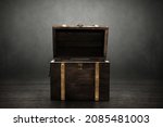 Small photo of Wooden treasure chest on dark background