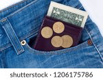 Small photo of Wallet and ready money are lying in side pocket of blue jeans.