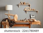Background image of carpenters workstation, carpenters work table with different tools, wood cutting, a jigsaw, a cipher machine, and a chair made in a carpentry workshop.