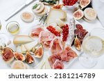 Small photo of Italian appetizer prosciutto ham mortadella salumi salami cheese appetizers served on a white marble platter with figs and red currants with crackers