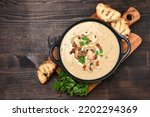 Mushroom champignon soup with bread and fresh mushrooms. top view , autumn seasonal cream soup with vegetables 