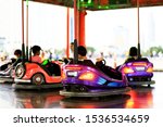 Childrens playing the bumper car at fun fair. Children's day concept.