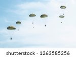 Parachutists jump from a...