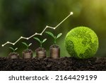  Light bulb is located on soil. plants grow on stacked coins Renewable energy generation is essential for the future. Renewable energy-based green business can limit climate change and global warming.