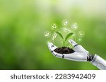 Small photo of Environmental technology concept. Robot hand holding small plants with Environment icon.Artificial Intelligence and Technology ecology. Green technology and Environmental technology.SDGs.Ai.