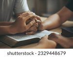 Small photo of Christian group of people Holding hands together and praying on the holy bible. devotional for prayer meeting concept. praying worship to believe. Encouraging each other to get through the crisis.Love