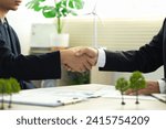 Small photo of Businessmen make handshakes with partners. business cooperation to comply with environmental laws. environmental protection.Ecosystem and Organization Development Cooperation. future and eco friendly