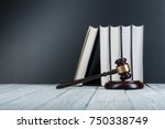 Law concept - Open law book with a wooden judges gavel on table in a courtroom or law enforcement office on blue background. Copy space for text