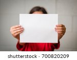 A Girl Holding Up A Blank Paper