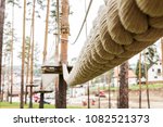 Suspension hanging rope bridge in an adventure park in the woods, outdoor activity adrenaline sport activity, detail macro closeup