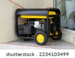 Small photo of Portable electric generator running in the cold winter.Energy genocide. Power outage as a result of missile strikes by Russia on energy facilities of Ukraine. Small business use gasoline generators