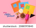 Small photo of Happy Makar Sankranti greeting card using Sweet Sesame or Tilgul Laddu in a bowl with haldi Kumkum, Kites and spool