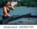 Small photo of Woman athlete wiping the water off her face with a hand while partake in one of the events of an obstacle course race. Female working out outside. Sport competition and OCR race. Copy space.