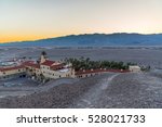 Sunset dusk at Furnace Creek Resort in Death Valley National Park with mountains in the background, and the hotel