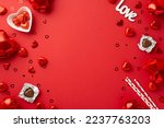 Saint Valentine's Day concept. Top view photo of heart shaped balloons plate with chocolate candies straws inscription love and confetti on isolated red background with copyspace