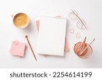 Valentine's Day concept. Top view photo of notepads golden pen glasses pink sticky note paper heart shaped clips pencils holder and cup of coffee on isolated white background with empty space