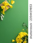 Small photo of Delve into Teacher's Day atmosphere with vertical top-view arrangement: yellow chrysanthemum bunch, giftbox, chalk, glasses, hearts. On green blackboard backdrop, find space for text incorporation