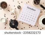 Small photo of Embrace International Coffee Day with overhead shot of calendar, roasted coffee beans, espresso cup, creamer jars, a coffee pot, a barista's scoop, turk, and kettle, set against pastel beige backdrop