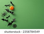 Small photo of Enter a world of Halloween magic! Top view of thematic decor: ghastly spider, small pumpkin, bats and more. Confetti intensify the eerie allure against a green backdrop with copy space