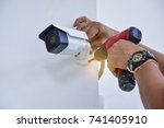 Technician installing CCTV camera for security