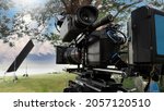 Small photo of Movie Camera. Behind the video camera that for recording film commercial or movie at outdoor location. 35 mm film styled 4K digital camera and tripod dolly crane for video production. film industry.
