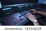 Small photo of Telecine controller machine and man hand editing or adjusting color on digital video movie or film in the post production stage.