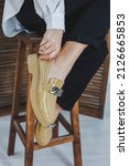 Small photo of Close-up of female legs in black jeans in stylish leather beige shoes. Fashionable woman in new loafers. Modern seasonal collection of stylish shoes. Women's fashion.